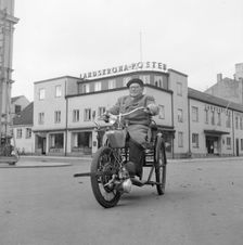 A disabled man with his motorised wheelchair, Landskrona, Sweden, 1952. Creator: Unknown