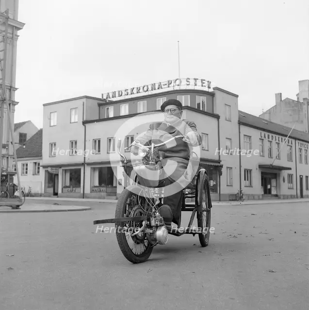 A disabled man with his motorised wheelchair, Landskrona, Sweden, 1952. Creator: Unknown.