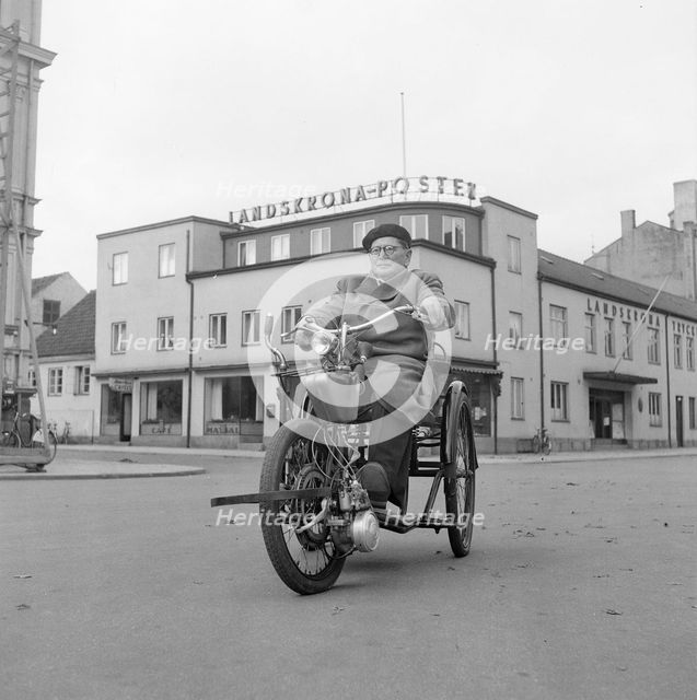A disabled man with his motorised wheelchair, Landskrona, Sweden, 1952. Creator: Unknown.
