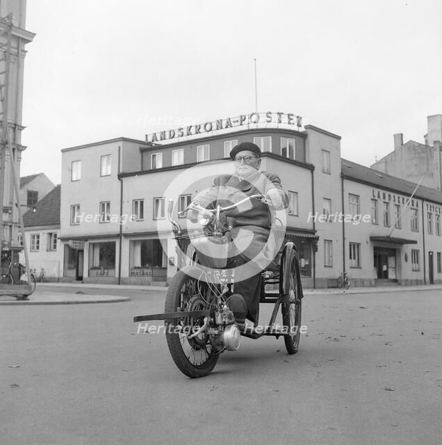 A disabled man with his motorised wheelchair, Landskrona, Sweden, 1952. Artist: Unknown