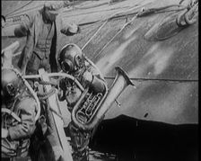 A Diver Coming up from the Sea Carrying a Tuba, 1929. Creator: British Pathe Ltd