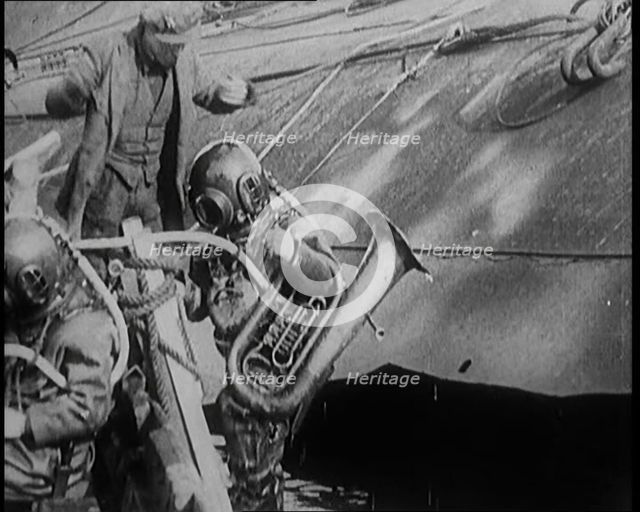 A Diver Coming up from the Sea Carrying a Tuba, 1929. Creator: British Pathe Ltd.