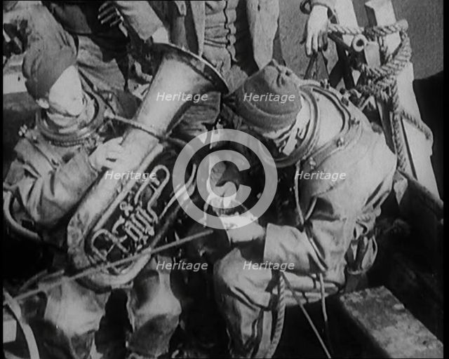 A Diver Coming up from the Sea Carrying a Tuba, 1929. Creator: British Pathe Ltd.