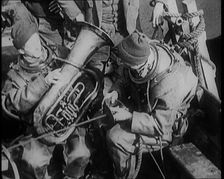 A Diver Coming up from the Sea Carrying a Tuba, 1929. Creator: British Pathe Ltd