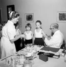 A doctor and his nurse vaccinate schoolgirls againgst polio, Landskrona, Sweden, 1957. Creator: Unknown