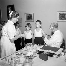 A doctor and his nurse vaccinate schoolgirls againgst polio, Landskrona, Sweden, 1957