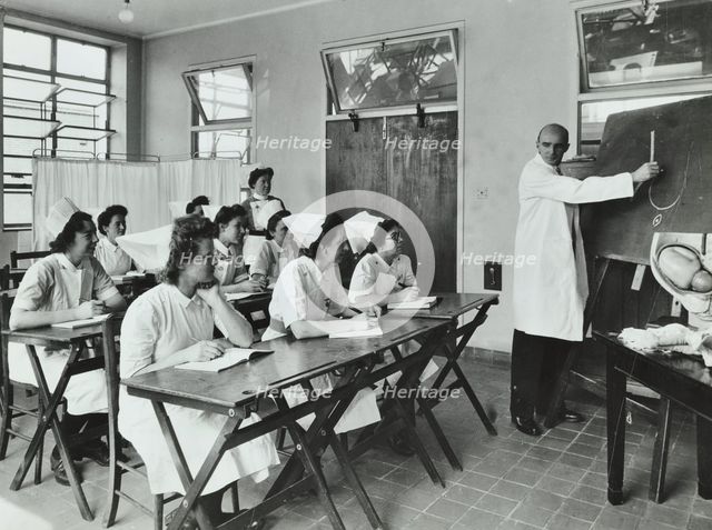 A doctor instructs trainee midwives, 1950s. Creator: Unknown.