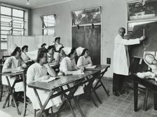 A doctor instructs trainee midwives, 1950s. Creator: Unknown
