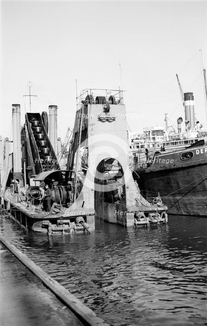 A dredger at work in Tilbury Docks, Essex, c1945-c1965.  Artist: SW Rawlings