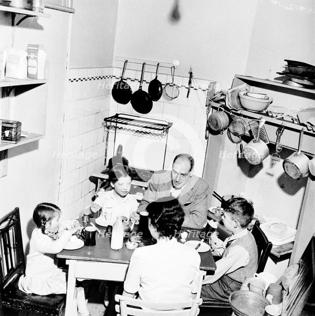 A family dining in their London home, c1950s. Creator: Henry Grant.