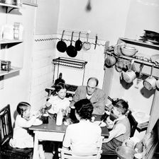 A family dining in their London home, c1950s. Creator: Henry Grant