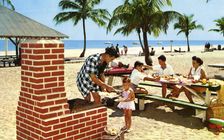A family enjoying a picnic and barbecue on a sandy beach in Florida, USA, 1957