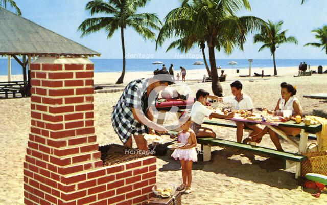 A family enjoying a picnic and barbecue on a sandy beach in Florida, USA, 1957. Artist: Unknown