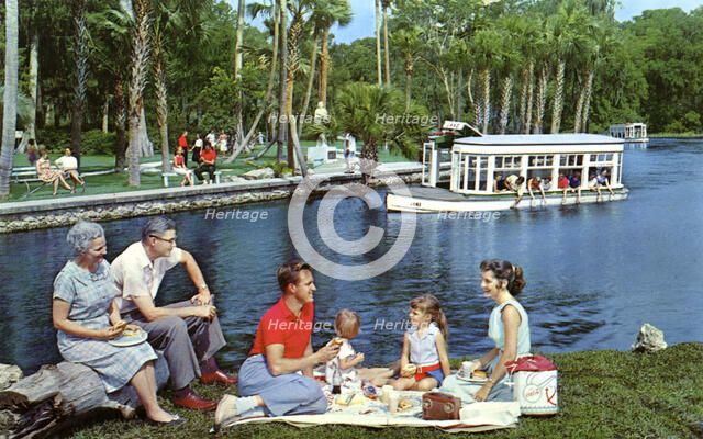 A family having a picnic beside the water, Silver Springs, Florida, USA, 1959. Artist: Mozert