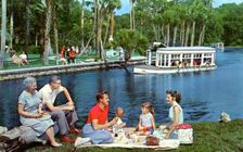 A family having a picnic beside the water, Silver Springs, Florida, USA, 1959. Artist: Mozert