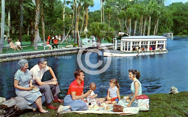 A family having a picnic beside the water, Silver Springs, Florida, USA, 1959. Artist: Mozert