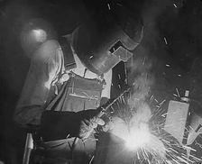 A Factory Worker Using a Blowtorch, 1943. Creator: British Pathe Ltd