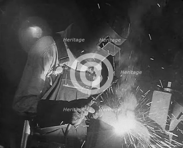 A Factory Worker Using a Blowtorch, 1943. Creator: British Pathe Ltd.