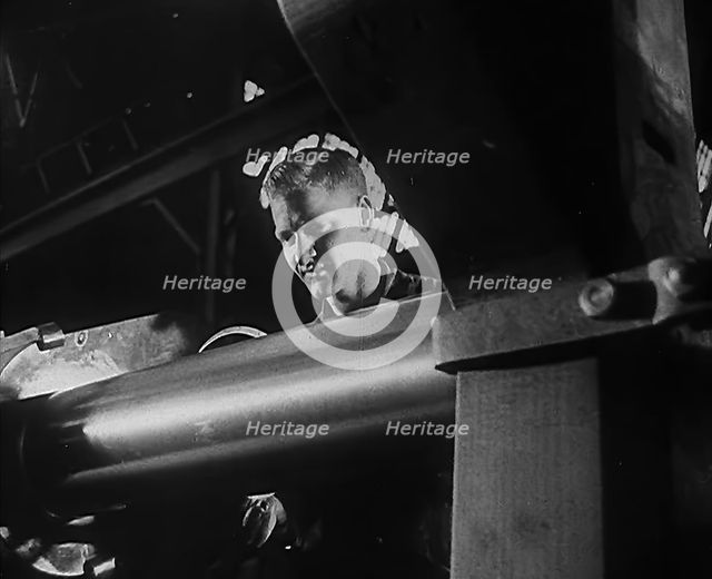 A Factory Worker Operating Machinery, 1943. Creator: British Pathe Ltd.