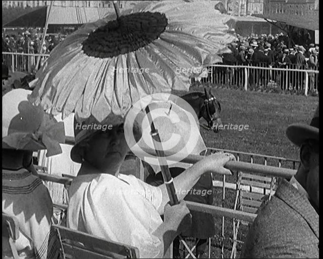 A Female Civilian Emerging from Behind a Sun Flower Shaped Parasol, 1920. Creator: British Pathe Ltd.