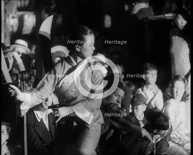 A Female Civilian in a Traditional Robe Dancing With Sabres As People Watch Her Performanc..., 1932. Creator: British Pathe Ltd.