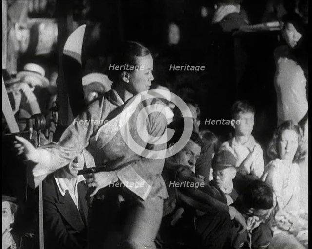A Female Civilian in a Traditional Robe Dancing With Sabres As People Watch Her Performanc..., 1932. Creator: British Pathe Ltd.