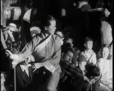 A Female Civilian in a Traditional Robe Dancing With Sabres As People Watch Her Performanc..., 1932. Creator: British Pathe Ltd