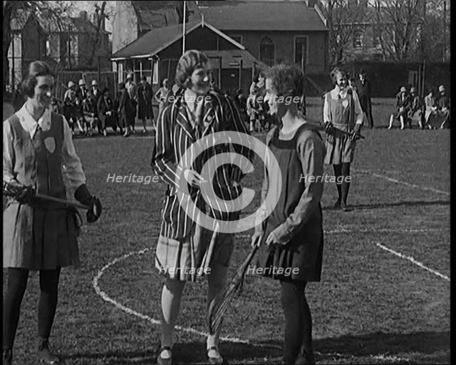 A Female Civilian Tossing a Coin in Front of Two Young Female Lacrosse Players Ahead of the..., 1920 Creator: British Pathe Ltd.