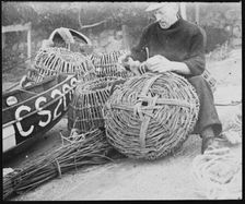 A fisherman making lobster pots at Steephill Cove, Ventnor, Isle Of Wight, 1930-1950. Creator: George R Long