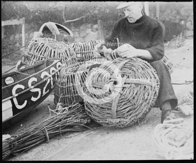 A fisherman making lobster pots at Steephill Cove, Ventnor, Isle Of Wight, 1930-1950. Creator: George R Long.