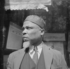 A follower of the late Marcus Garvey who started the "Back to Africa" movement, New York, 1943. Creator: Gordon Parks