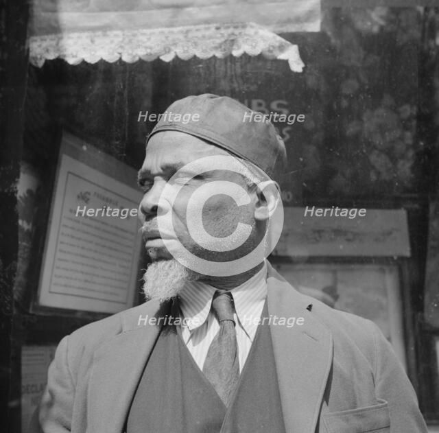 A follower of the late Marcus Garvey who started the "Back to Africa" movement, New York, 1943. Creator: Gordon Parks.