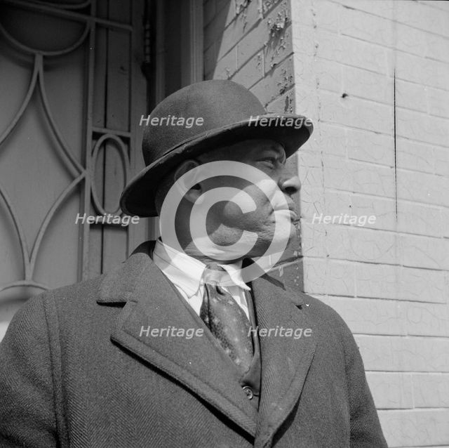 A follower of the late Marcus Garvey who started the "Back to Africa" movement, New York, 1943. Creator: Gordon Parks.