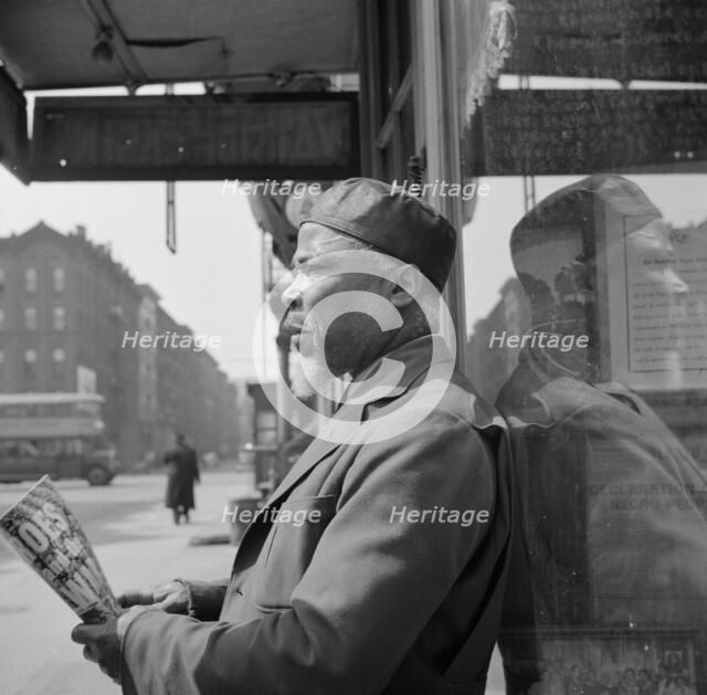 A follower of the late Marcus Garvey who started the "Back to Africa" movement, New York, 1943. Creator: Gordon Parks.
