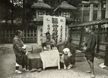 A Fortune-Teller at Inari Temple 1910. Creator: Herbert Ponting