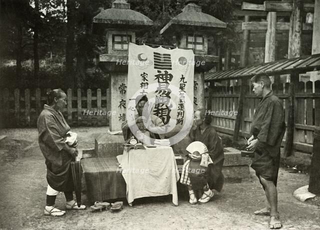 'A Fortune-Teller at Inari Temple', 1910. Creator: Herbert Ponting.