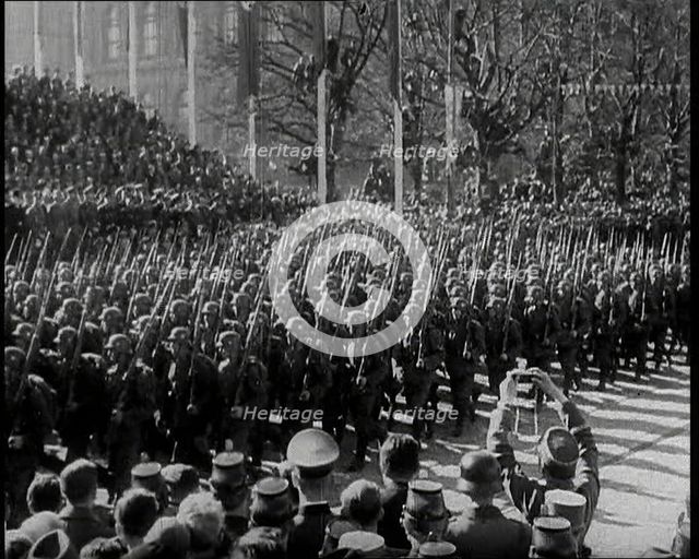 A Formation of Male German Soldiers Marching Past a Raked Platform of Officials on a Vienna..., 1938 Creator: British Pathe Ltd.