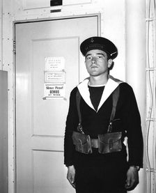 A French sentry outside the operations room of the aircraft carrier La Fayette 1951