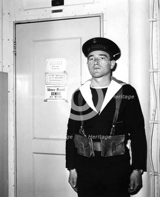 A French sentry outside the operations room of the aircraft carrier 'La Fayette', 1951. Artist: Unknown