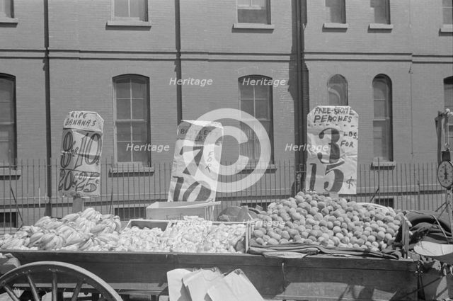 A fruit and vegetable vendor stand, 61st Street between 1st and 3rd Avenues, New York, 1938. Creator: Walker Evans.