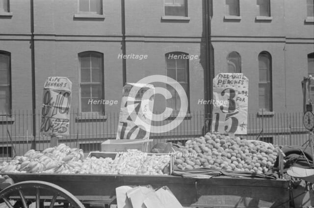 A fruit and vegetable vendor stand, 61st Street between 1st and 3rd Avenues, New York, 1938. Creator: Walker Evans.