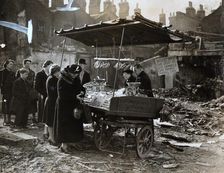 A fruit stall in a bomb wrecked clearing, London, World War II, c1940-c1945