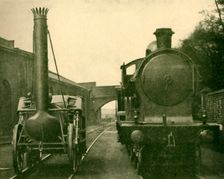 A full size model of Stephenson's Rocket alongside an engine of the "George the Fifth" class, Londo Creator: Unknown