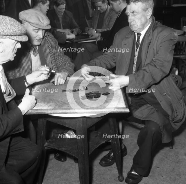 A game of dominoes in a miners' welfare club, Horden, County Durham, 1963. Artist: Michael Walters