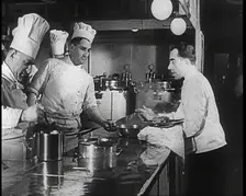 A Galley With Kitchen Staff Cooking and Waiters With Dishes on Board the Strength Through..., 1939. Creator: British Pathe Ltd