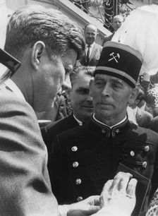 A German miner presenting President John F. Kennedy with a mine lamp, Bonn, Germany, 1963