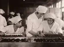 A girl is taught how to hand-pipe chocolates, Rowntree factory, York, Yorkshire, 1933