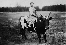 A girl riding a bull, 1890. Creator: Unknown