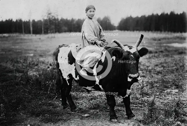 A girl riding a bull, 1890. Creator: Unknown.