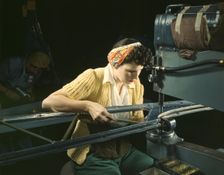 A girl riveting machine operator at the Douglas Aircraft Company plant..., Long Beach, Calif. , 1942 Creator: Alfred T Palmer